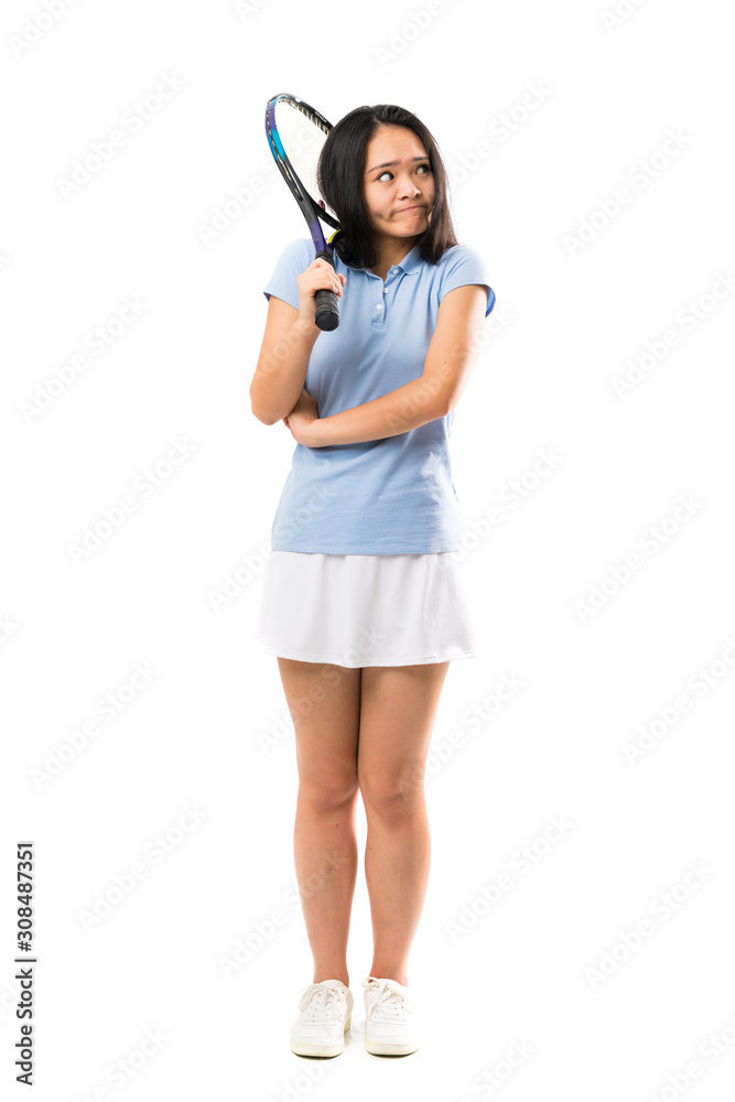 Young asian tennis player over isolated white background making doubts gesture while lifting the shoulders Young asian tennis player over isolated white background making doubts gesture while lifting the shoulders