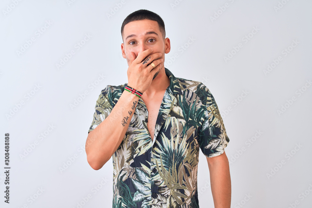 Young handsome man wearing Hawaiian summer shirt over isolated background shocked covering mouth with hands for mistake. Secret concept. Young handsome man wearing Hawaiian summer shirt over isolated background shocked covering mouth with hands for mistake. Secret concept.