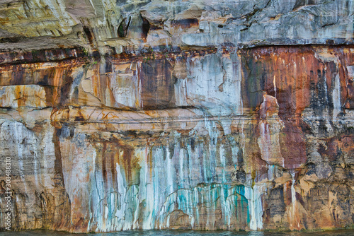 Landscape of mineral stained cliff along the eroded sandstone shoreline of Lake Superior, Pictured Rocks National Lakeshore, Michigan’s Upper Peninsula