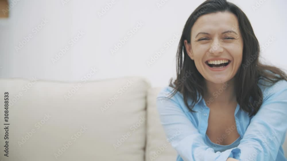 Beautiful, pretty cute and funny woman is smiling widely and feeling fine. Woman is isolated on white background. Slow motion. 4K. Beautiful, pretty cute and funny woman is smiling widely and feeling fine. Woman is isolated on white background. Slow motion. 4K.