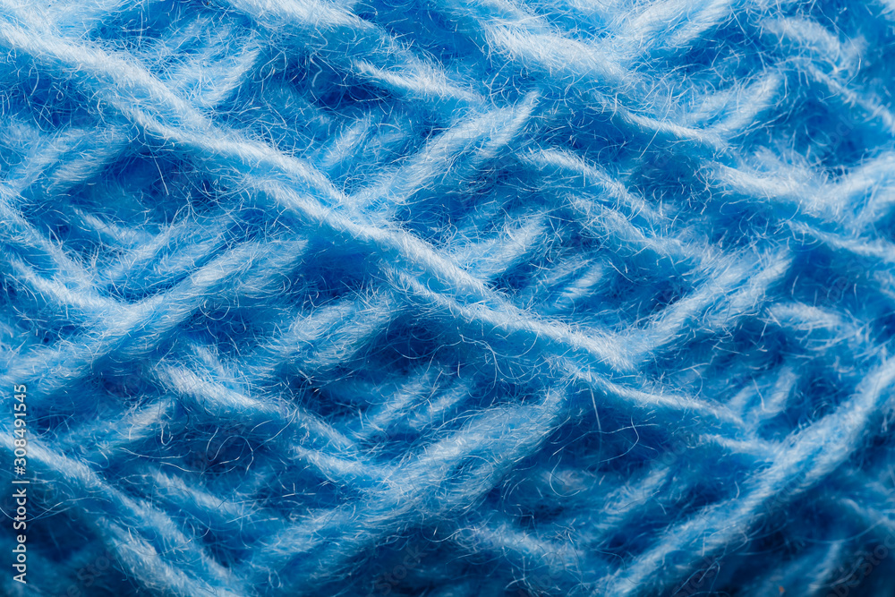 Fototapeta premium Wool yarn close-up colorful blue threads for needlework in macro.