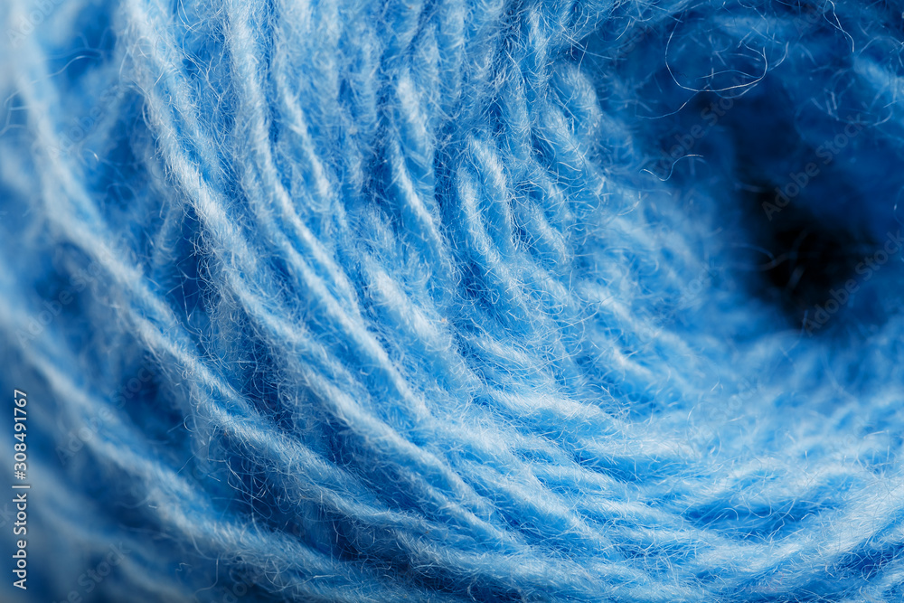 Obraz premium Wool yarn close-up colorful blue threads for needlework in macro.