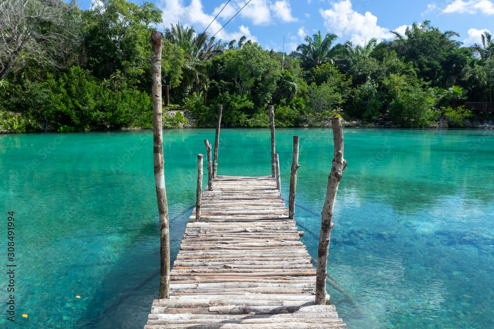 Cozumel, Quintana Roo / Mexico - 11 07 2019: Bridge over Clear Blue Water in Chankanaab Beach Adventure Park, Cozumel, Quintana Roo, Mexico