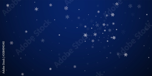 Sparse snowfall Christmas background. Subtle flyin photo