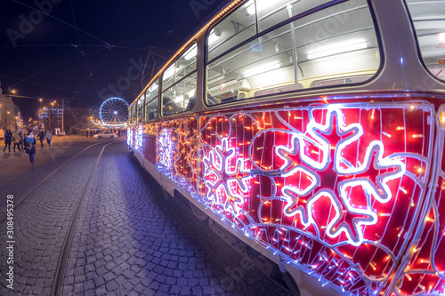 Christmas special tram illuminated by light with Christmas motif in Brno on traditional Moravian markets.