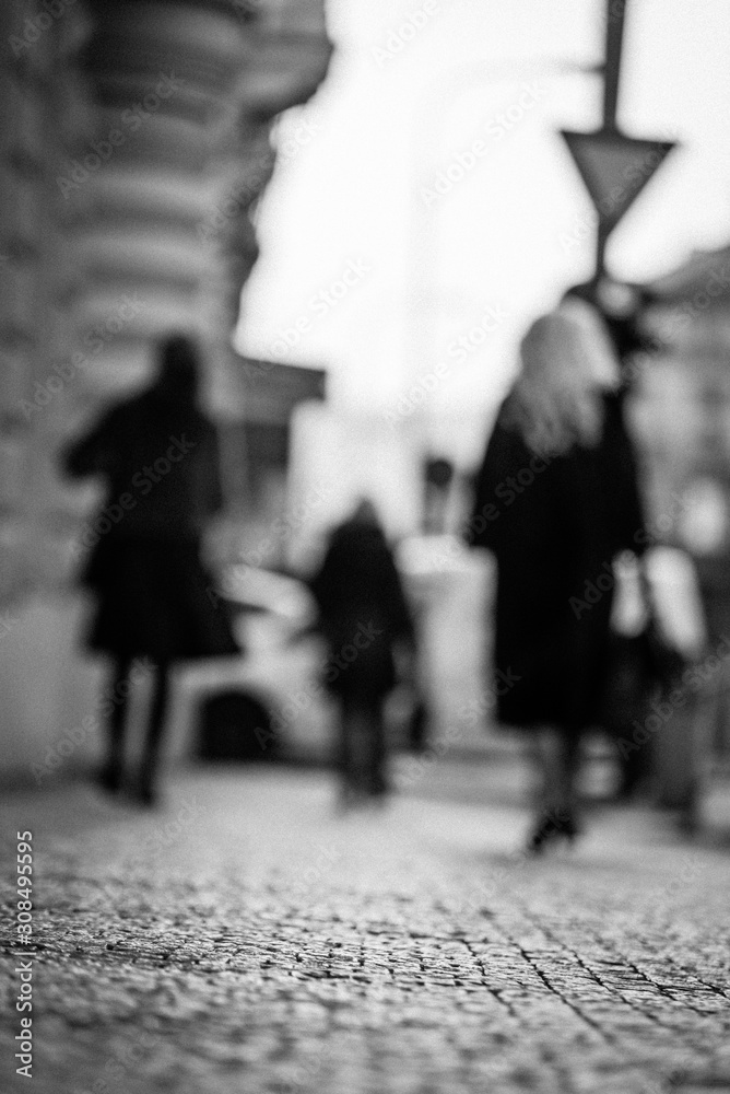 blurred group of people walking the streets of proague
