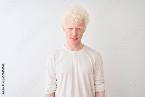 Young albino blond man wearing casual t-shirt standing over isolated white background skeptic and nervous, frowning upset because of problem. Negative person.