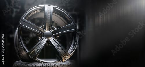 beautiful black alloy wheels made of aluminum on a dark background. exclusive wheels for expensive cars. Close up, copyspace