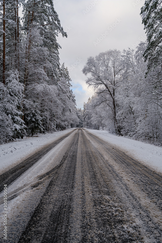 car tracks in the snow on the winter road in sunny day car tracks in the snow on the winter road in sunny day