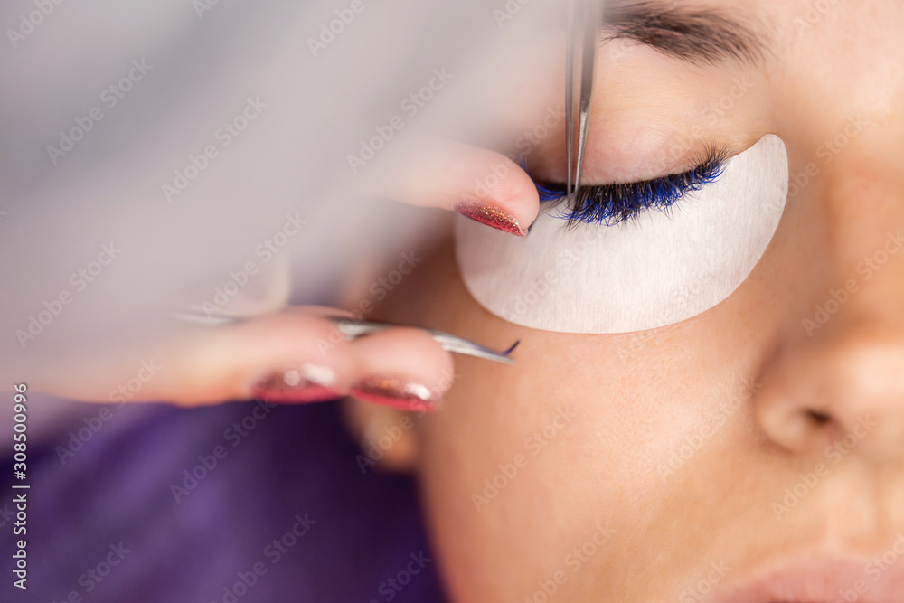 Woman on a cosmetic procedure for eyelash extension. Face and eyes close up.