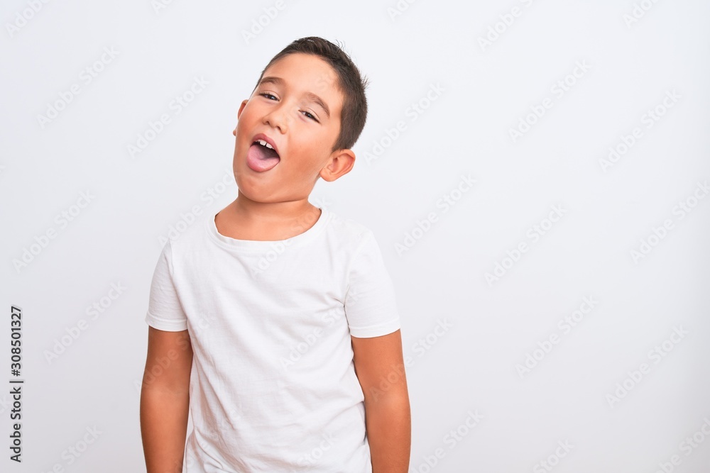 Beautiful kid boy wearing casual t-shirt standing over isolated white background sticking tongue out happy with funny expression. Emotion concept. Beautiful kid boy wearing casual t-shirt standing over isolated white background sticking tongue out happy with funny expression. Emotion concept.