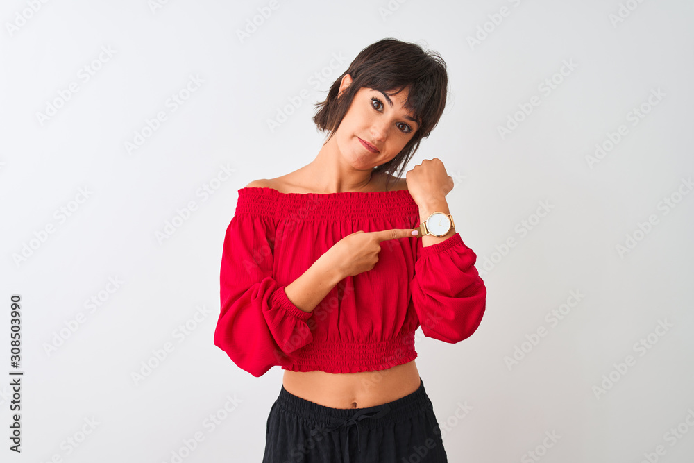 Young beautiful woman wearing red summer t-shirt standing over isolated white background In hurry pointing to watch time, impatience, looking at the camera with relaxed expression Young beautiful woman wearing red summer t-shirt standing over isolated white background In hurry pointing to watch time, impatience, looking at the camera with relaxed expression