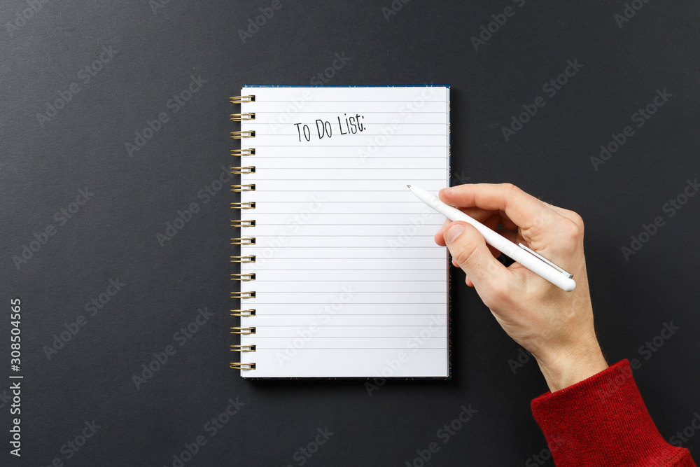 to do list notebook with black pen in hands to do list notebook with black pen in hands