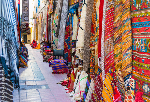 Moroccan carpets with traditional ornaments for sale in the street of Essaouira, Morocco © leelook