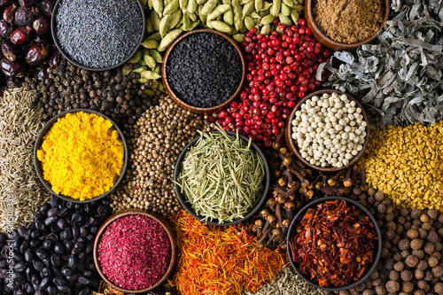Fototapeta Naklejka Na Ścianę i Meble -  Indian spices and herbs as background for packing labels with food.