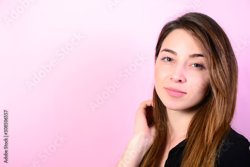Beauty cute fashion model with natural make up on pink background.
