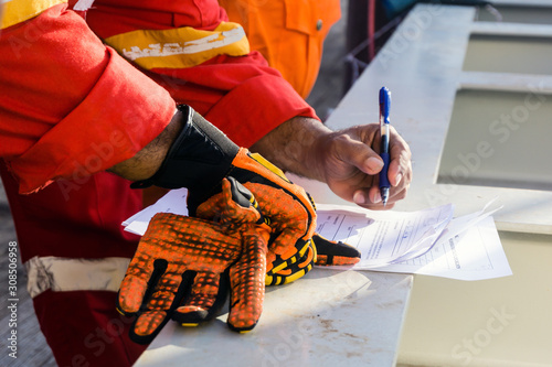 Fényképezés A supervisor signed a pre-job checklist on board a construction work barge prior