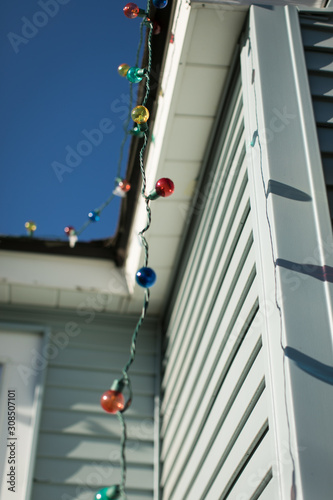 String of Christmas lights hanging from house gutters