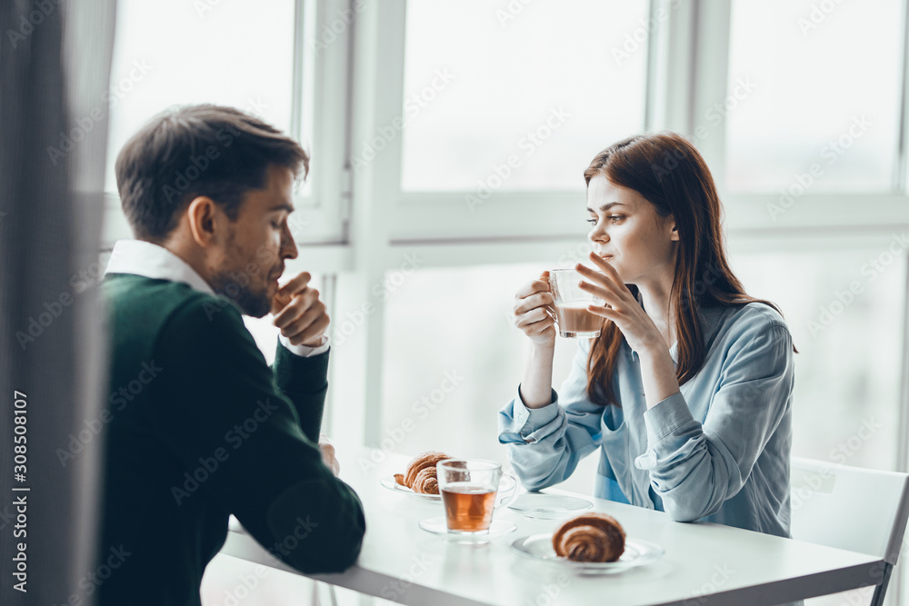 young couple having breakfast in cafe young couple having breakfast in cafe