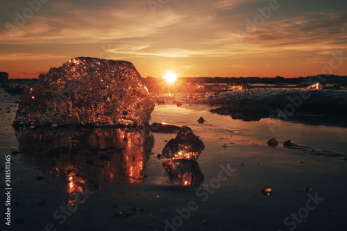 Fotografi Pieces of beautiful transparent ice in pink and amber colors as a jewels shining