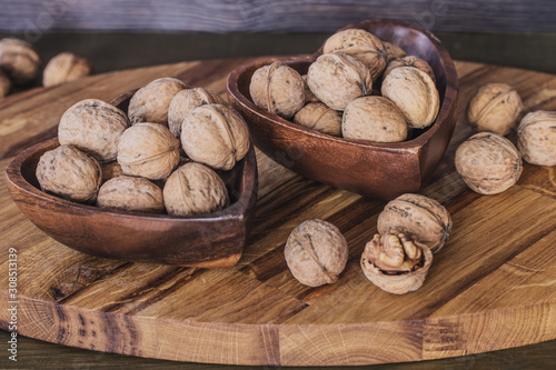 walnuts in a wooden bowl closeup. background with walnuts closeup.