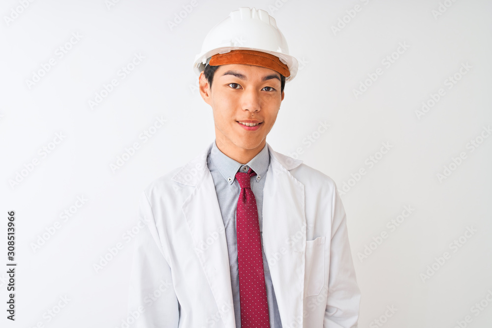 Chinese architect man wearing coat and helmet standing over isolated white background with a happy and cool smile on face. Lucky person. Chinese architect man wearing coat and helmet standing over isolated white background with a happy and cool smile on face. Lucky person.