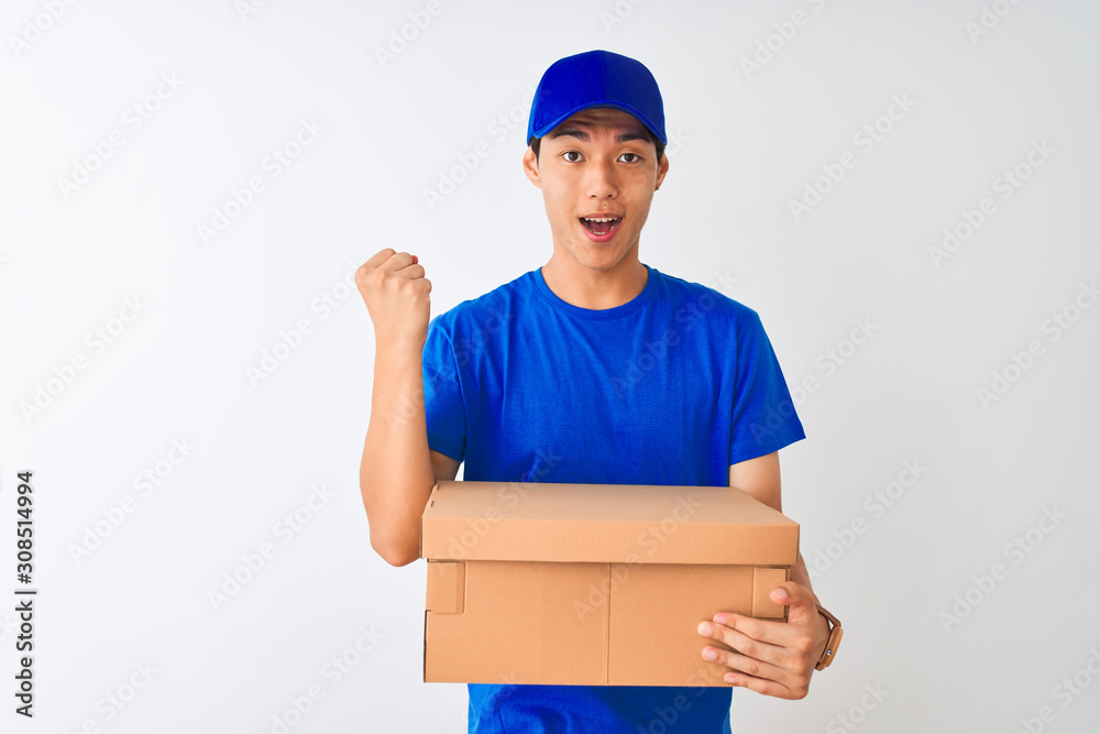 Chinese deliveryman wearing cap holding box standing over isolated white background screaming proud and celebrating victory and success very excited, cheering emotion Chinese deliveryman wearing cap holding box standing over isolated white background screaming proud and celebrating victory and success very excited, cheering emotion