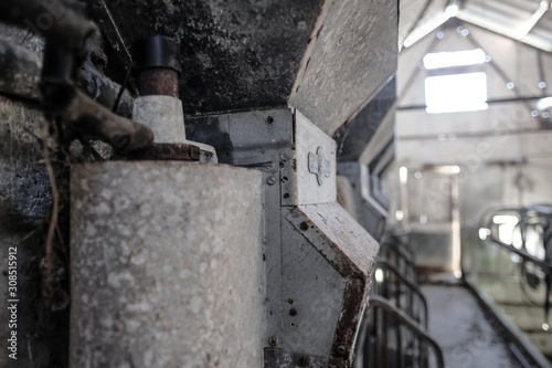 Shallow focus of a disused grain feed hopper seen in a derelict milking parlour. Used to feed livestock while being milked on the dairy farm. 