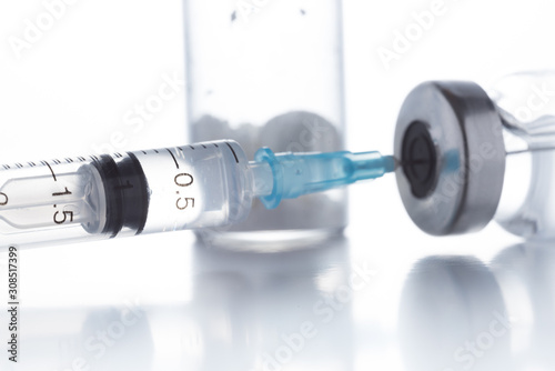 Antibiotic injection bottles with a plastic disposable syringe on a white background