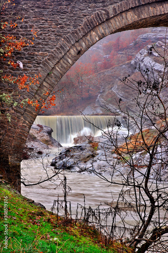 Old stone, arched bridge and waterfall at Chrysavgi village, Voio mountain, Kozani, Macedonia, Greece photo