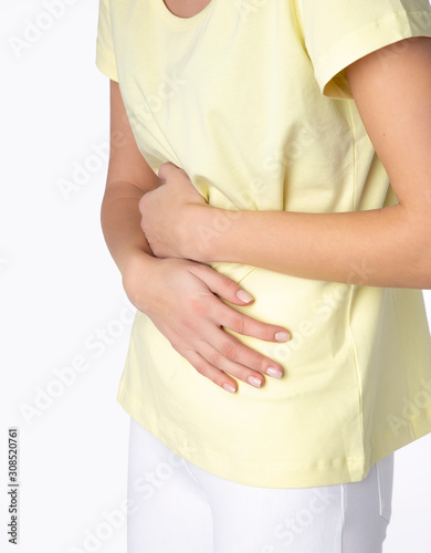 Wallpaper Mural Young beautiful woman having painful stomachache on white background.Chronic gastritis. Abdomen bloating concept Torontodigital.ca