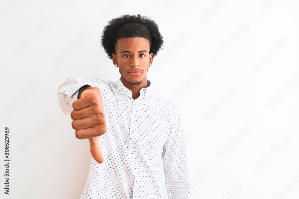 Young african american man wearing elegant shirt standing over isolated white background looking unhappy and angry showing rejection and negative with thumbs down gesture. Bad expression. Young african american man wearing elegant shirt standing over isolated white background looking unhappy and angry showing rejection and negative with thumbs down gesture. Bad expression.