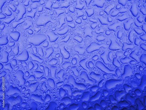 Blurred defocused blue abstract texture dew drops water background.