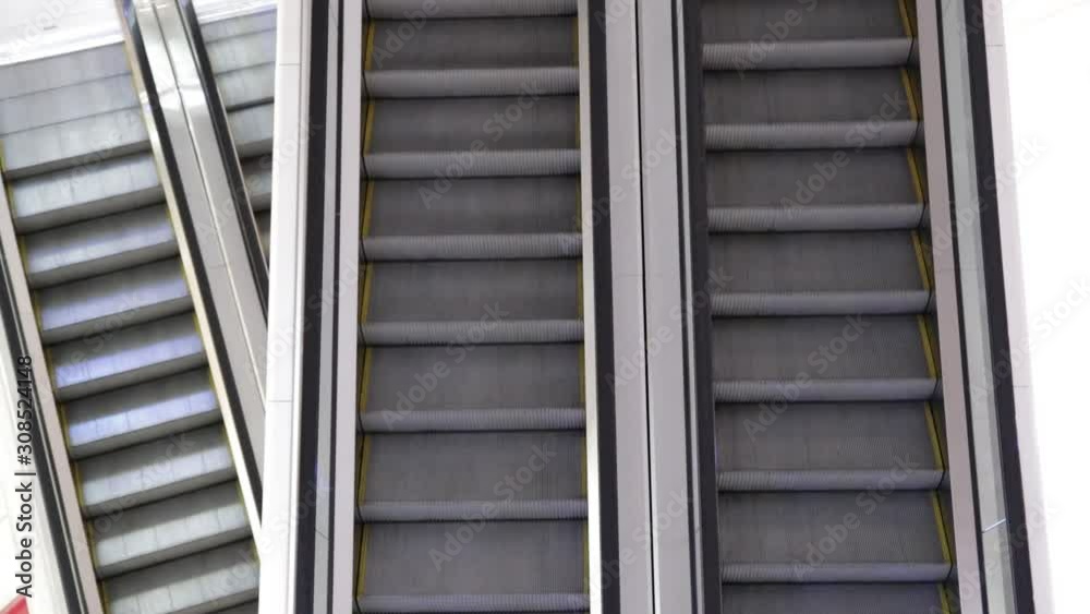 The escalator in two directions up and down constantly moves in public places. Escalator Top view. The escalator in two directions up and down constantly moves in public places. Escalator Top view.