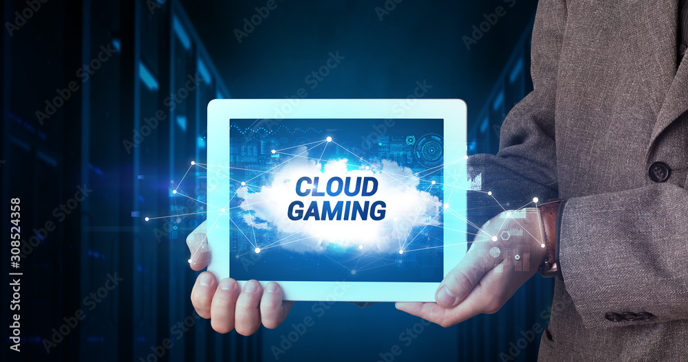 Young business person working on tablet and shows the inscription: CLOUD GAMING Young business person working on tablet and shows the inscription: CLOUD GAMING