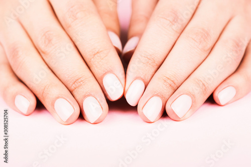 Female s hands with classic pastel manicure.