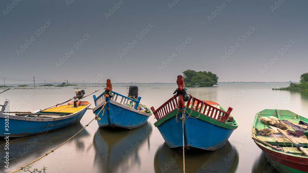Shot of Fishing boats parked near still lake of Bhigwan, Maharashtra