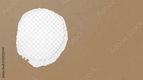 A hole in the ripped recycled paper background. Cardboard or paperboard kraft paper frame