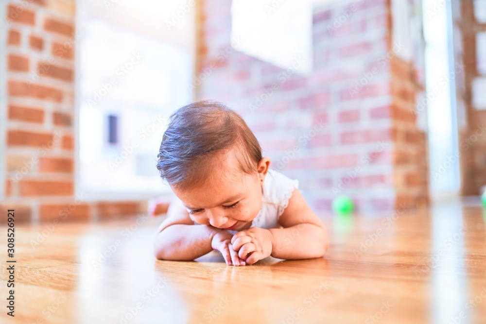 Beautiful infant happy at kindergarten around colorful toys Beautiful infant happy at kindergarten around colorful toys