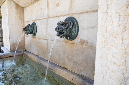 Street fountain in Geneva, Switzerland. Fountains with drinkable water are very common in Swiss cities. Potable water in the city photo