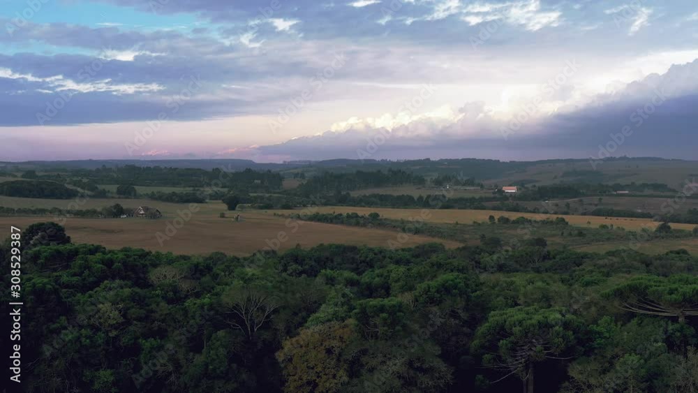 Beautiful aerial scenic panoramic view of countryside green farm fields and forests with a colorful sky Beautiful aerial scenic panoramic view of countryside green farm fields and forests with a colorful sky