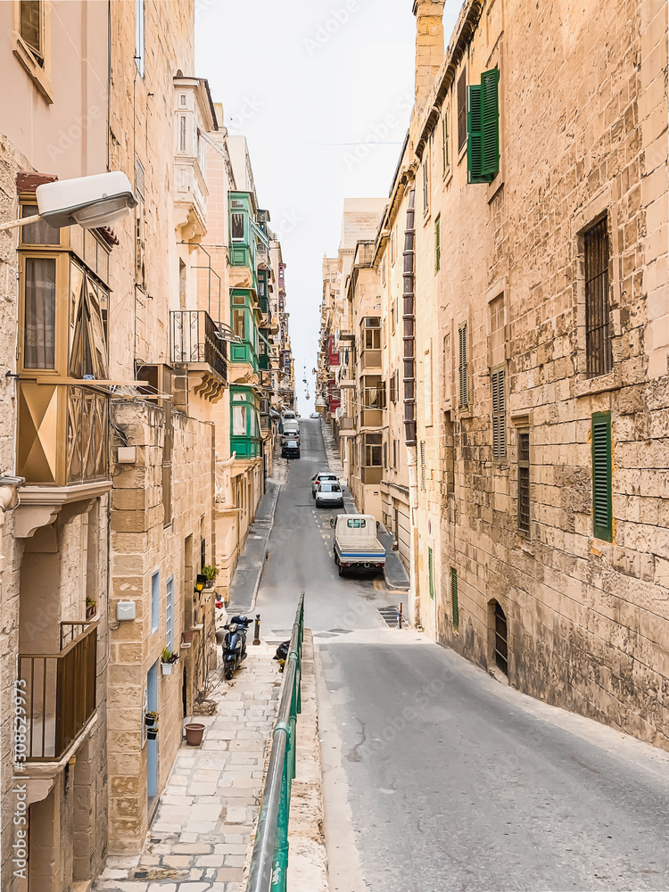 Traditional Maltese street in Valetta, Malta with traditional balconies and slope. Travel and tourism in Malta concept. Cityscape of Valletta. Architecture of Valetta.