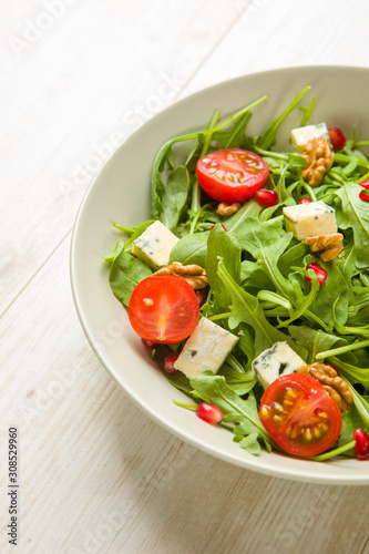 Fresh salad with tomatoes , blue cheese and nuts