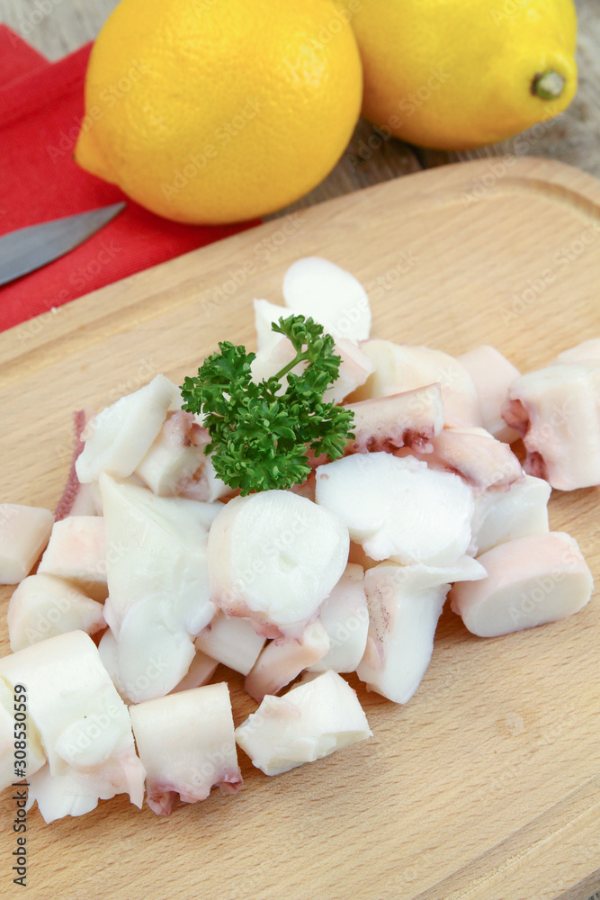 pieces of octopus cooked on a cutting board pieces of octopus cooked on a cutting board