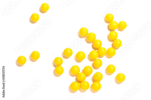 round yellow pills on a white isolated background