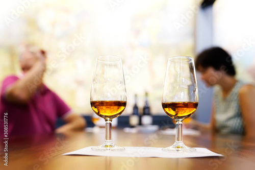 wine tasting sampling with couple drinking , selective focus on wine glasses , Madeira island