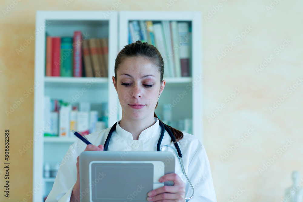 Portrait of young female doctor using digital tablet Portrait of young female doctor using digital tablet