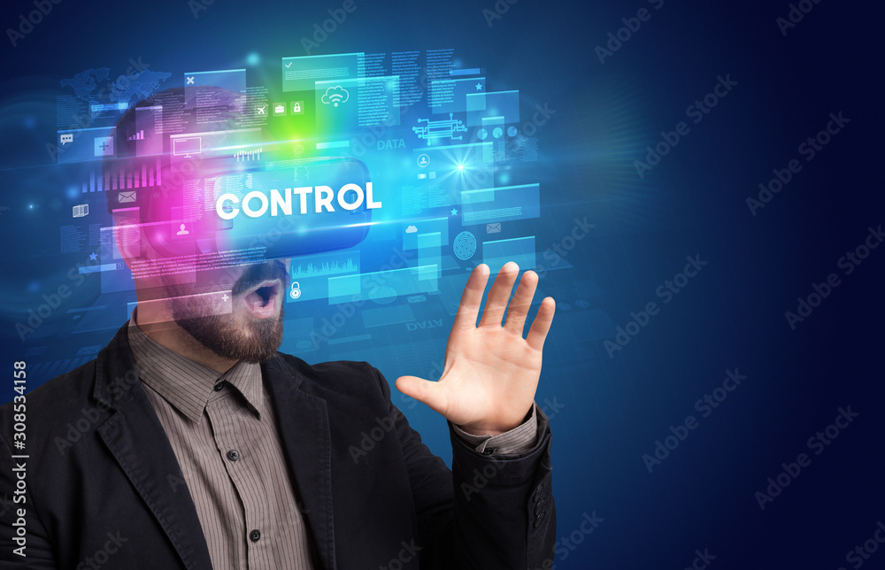 Businessman looking through Virtual Reality glasses with CONTROL inscription, innovative security concept Businessman looking through Virtual Reality glasses with CONTROL inscription, innovative security concept