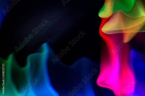 Vibrant rainbow made with lights on a dark background photo