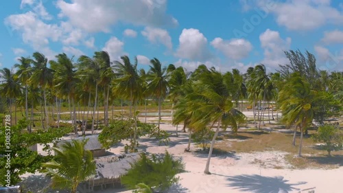 White sand beach and tropical island surrounded by palm trees at Punta Sebaring, Bugsuk Island in Balabac, Philippines photo